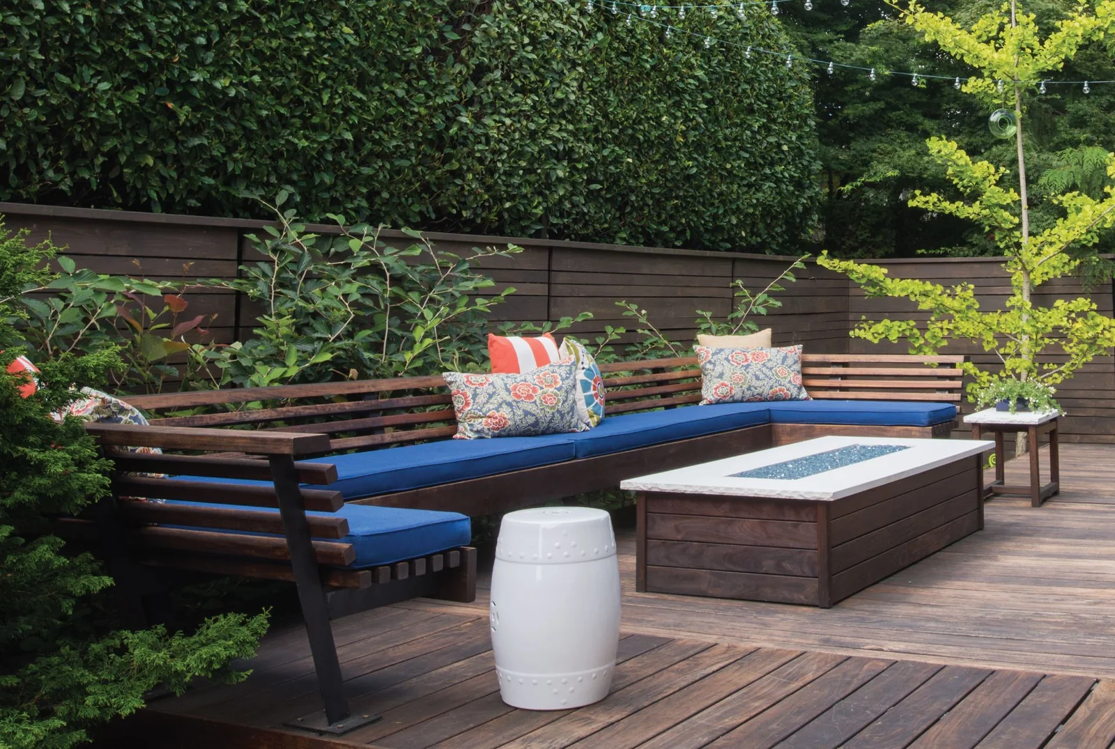 Firepit lounge with built-in timber seating on a wooden deck